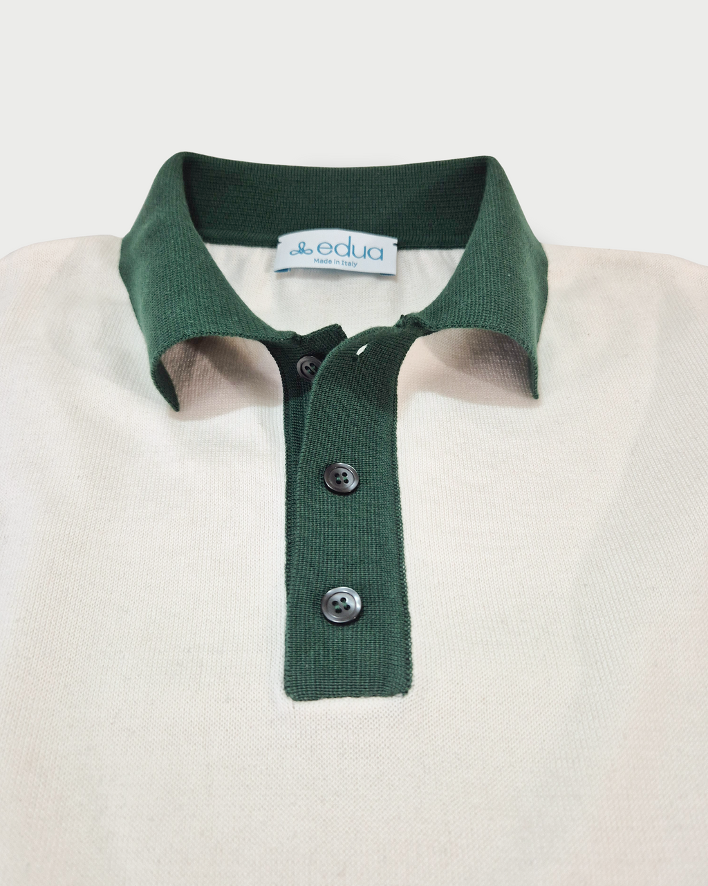 dettaglio colletto verde con bottoni Polo uomo in maglia di cotone écru con colletto verde su sfondo bianco